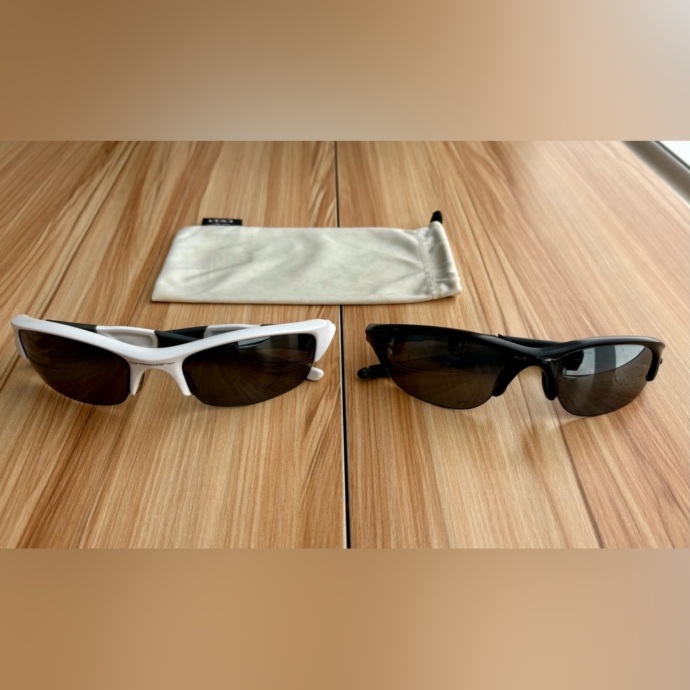 Two Pairs of Oakley Sunglasses with one Oakley bag.